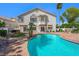 Beautiful backyard oasis with a large pool, mature trees, and a cozy patio, creating a private retreat at 2097 Eaglepath Cir, Henderson, NV 89074