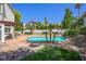 Inviting backyard with a pristine pool, decorative rock features, and ample space for relaxation and recreation at 2097 Eaglepath Cir, Henderson, NV 89074