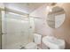 Bathroom features a glass-enclosed shower, toilet, and stylish round mirror above the sink at 2097 Eaglepath Cir, Henderson, NV 89074