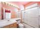 Bright bathroom featuring a shower, vanity, and large mirror at 2097 Eaglepath Cir, Henderson, NV 89074