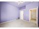 A cozy bedroom featuring light purple walls, plush carpet, and a ceiling fan at 2097 Eaglepath Cir, Henderson, NV 89074