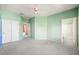 Spacious bedroom with ensuite bathroom, ceiling fan, neutral carpet, and ample closet space at 2097 Eaglepath Cir, Henderson, NV 89074