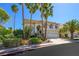 Beautiful two-story home with a well-maintained front yard and tall palm trees, creating a welcoming curb appeal at 2097 Eaglepath Cir, Henderson, NV 89074
