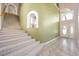 Open foyer with staircase, chandelier, and glass-accented front doors, offering a grand entrance at 2097 Eaglepath Cir, Henderson, NV 89074
