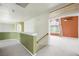 Hallway leading to a cozy room with warm paint and lots of natural light at 2097 Eaglepath Cir, Henderson, NV 89074
