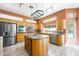 Bright kitchen features stainless appliances, granite counters, and a center island with seating at 2097 Eaglepath Cir, Henderson, NV 89074