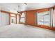 Spacious living room featuring a ceiling fan, lots of windows, neutral carpet, and an archway at 2097 Eaglepath Cir, Henderson, NV 89074