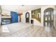 Open living room with tile and carpet flooring, fireplace, and staircase with decorative archways at 2097 Eaglepath Cir, Henderson, NV 89074