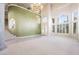 Expansive living room with soaring ceilings, a grand staircase, and abundant natural light, creating an impressive space at 2097 Eaglepath Cir, Henderson, NV 89074