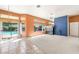 Bright living room with tile and carpet flooring and sliding glass doors leading to the pool at 2097 Eaglepath Cir, Henderson, NV 89074
