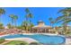 A community pool offers cool relaxation amidst palm trees, and lush landscaping at 2097 Eaglepath Cir, Henderson, NV 89074