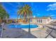 The backyard features a pool, a large palm tree, pergola, and a wooden fence under a clear sky at 2129 N Michael Way, Las Vegas, NV 89108