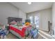 Bright bedroom featuring a queen bed, natural light, and access to the outdoor area at 2129 N Michael Way, Las Vegas, NV 89108
