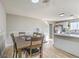 Open dining area adjacent to kitchen with barstool seating and wood-look floors at 2129 N Michael Way, Las Vegas, NV 89108