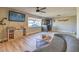 Spacious living room with a large window, modern furnishings, and a ceiling fan at 2129 N Michael Way, Las Vegas, NV 89108