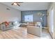 Inviting living room featuring a large sectional sofa and wood-look floors at 2129 N Michael Way, Las Vegas, NV 89108