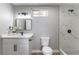 Bathroom featuring a tiled walk-in shower, modern vanity, mirror, and light fixture at 2346 Roan Ave, Las Vegas, NV 89119