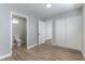 Bedroom featuring wood-look floors, closet, and a doorway to the newly renovated bathroom at 2346 Roan Ave, Las Vegas, NV 89119