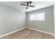 Bright bedroom featuring wood-look flooring, neutral walls, and a modern ceiling fan at 2346 Roan Ave, Las Vegas, NV 89119