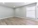 Spacious bedroom offering wood-look floors, recessed lights, and large window at 2346 Roan Ave, Las Vegas, NV 89119