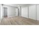 Large bedroom featuring wood-look flooring, ample closet space, and access to bathroom at 2346 Roan Ave, Las Vegas, NV 89119