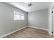 Bright bedroom with wood-look flooring and a window that allows in natural light at 2346 Roan Ave, Las Vegas, NV 89119