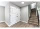 Bright entryway featuring modern wood-look floors, a staircase, and a white paneled front door at 2346 Roan Ave, Las Vegas, NV 89119