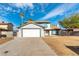 Charming two-story home with a spacious driveway, attached garage, and a landscaped yard in a sunny neighborhood at 2346 Roan Ave, Las Vegas, NV 89119