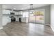 Modern kitchen with white cabinetry, stainless steel appliances, and a sliding glass door to the backyard at 2346 Roan Ave, Las Vegas, NV 89119