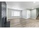 Open-concept living room featuring a fireplace, front door, staircase, and large window at 2346 Roan Ave, Las Vegas, NV 89119