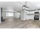 Open floorplan with living room, dining area, and kitchen with white cabinetry and stainless-steel appliances at 2346 Roan Ave, Las Vegas, NV 89119