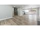 Spacious open-concept living space with wood-look floors, a staircase, and a modern kitchen at 2346 Roan Ave, Las Vegas, NV 89119