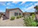 Well-maintained backyard with mature shrubs and a covered patio area at 2349 Orangeburg Pl, Henderson, NV 89044
