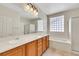 Bright bathroom with double sinks, soaking tub, and glass block window at 2349 Orangeburg Pl, Henderson, NV 89044