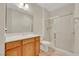 Bathroom features a wood vanity, a large mirror, a toilet and a glass-enclosed shower at 2349 Orangeburg Pl, Henderson, NV 89044