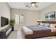 Cozy bedroom with a soft rug, modern decor, and a large window at 2349 Orangeburg Pl, Henderson, NV 89044