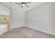 This bedroom features neutral paint, carpet, a ceiling fan and a view to other living spaces at 2349 Orangeburg Pl, Henderson, NV 89044