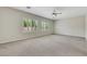 Large bonus room featuring neutral paint, plush carpet, and multiple windows with natural light at 2349 Orangeburg Pl, Henderson, NV 89044