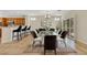 Bright dining room showcasing a glass table with modern decor and an open view to the kitchen area at 2349 Orangeburg Pl, Henderson, NV 89044
