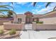 Inviting front exterior featuring a gated entrance, manicured landscaping, stucco walls, and a tile roof at 2349 Orangeburg Pl, Henderson, NV 89044