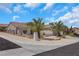 Charming single-story home featuring desert landscaping with two palm trees, a beige exterior, and a tiled roof at 2349 Orangeburg Pl, Henderson, NV 89044