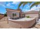 Inviting front exterior with stucco walls, desert landscaping, and a spacious driveway, perfect for curb appeal at 2349 Orangeburg Pl, Henderson, NV 89044