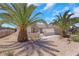 Beautiful home featuring desert landscaping, a private gate, and mature palm trees at 2349 Orangeburg Pl, Henderson, NV 89044