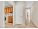 Hallway showcases wood cabinets with sink and washer/dryer, and tile floors leading to other rooms at 2349 Orangeburg Pl, Henderson, NV 89044