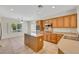 Bright kitchen featuring an island, stainless steel appliances, and a window overlooking the yard at 2349 Orangeburg Pl, Henderson, NV 89044