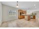 Eat-in kitchen showcases tile flooring, wood cabinetry, stainless steel appliances and natural light from shuttered window at 2349 Orangeburg Pl, Henderson, NV 89044