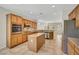 Bright kitchen featuring an island, stainless steel appliances, and wooden cabinetry at 2349 Orangeburg Pl, Henderson, NV 89044