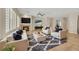 Elegant living room showcasing neutral decor, a cozy fireplace, and ample natural light from the shuttered windows at 2349 Orangeburg Pl, Henderson, NV 89044