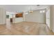 Open-concept living room featuring tile flooring, a chandelier, and sliding glass doors to the backyard at 2349 Orangeburg Pl, Henderson, NV 89044