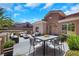 Relaxing outdoor patio with a dining table, seating, and lush greenery, perfect for entertaining and enjoying the weather at 2349 Orangeburg Pl, Henderson, NV 89044